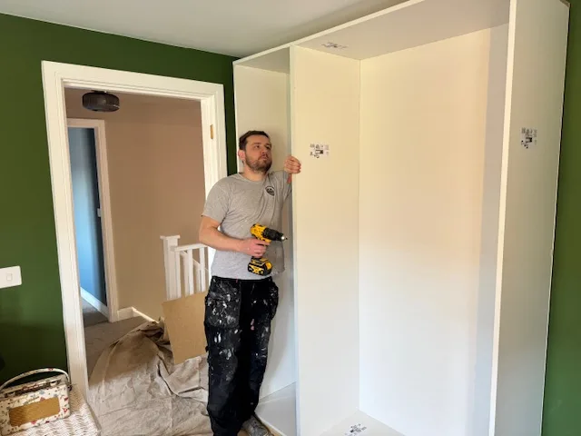Jonathan and his son installing bespoke fitted wardrobes in Cardiff